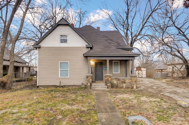 view of front of home with a front yard and a porch