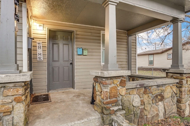 property entrance featuring a porch