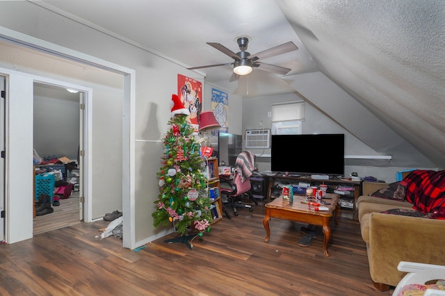 living room with vaulted ceiling, ceiling fan, dark wood-type flooring, and a textured ceiling