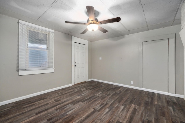 spare room featuring a paneled ceiling, ceiling fan, and dark hardwood / wood-style flooring