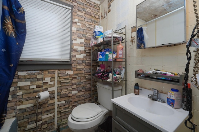 bathroom with tasteful backsplash, vanity, and toilet