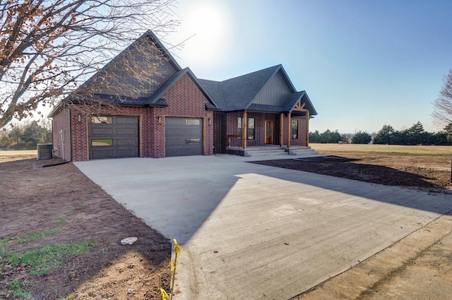 view of front of house featuring central AC and a garage