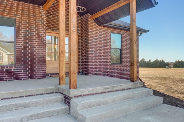 view of exterior entry with a porch