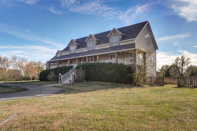 cape cod home with a front yard