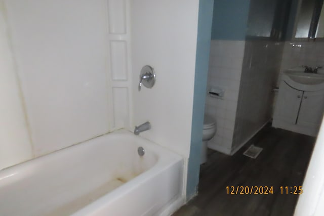 bathroom featuring sink, wood-type flooring, and toilet