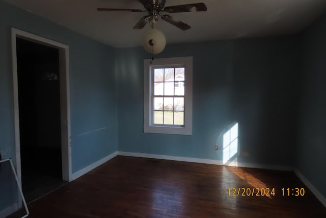 spare room featuring ceiling fan and dark hardwood / wood-style floors