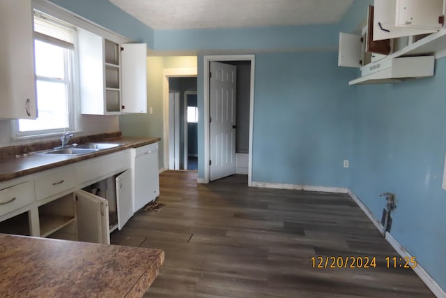 kitchen with white cabinets, dishwasher, sink, and dark wood-type flooring