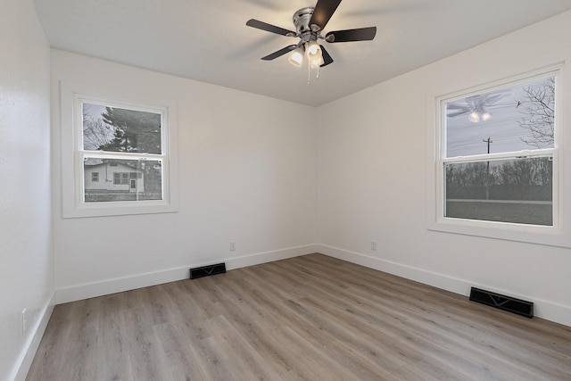 spare room featuring ceiling fan and light hardwood / wood-style floors