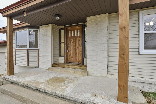 doorway to property featuring covered porch