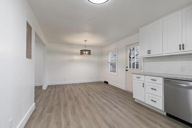 kitchen with light stone countertops, stainless steel dishwasher, backsplash, decorative light fixtures, and white cabinets