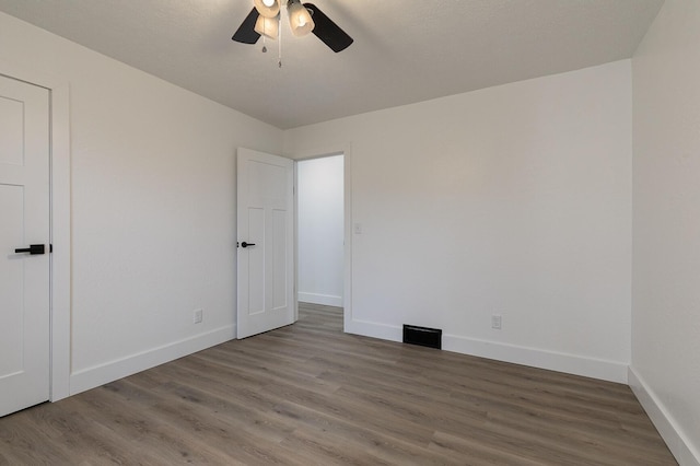 unfurnished room featuring ceiling fan and wood-type flooring