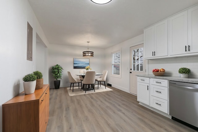 kitchen featuring tasteful backsplash, pendant lighting, white cabinets, and stainless steel dishwasher