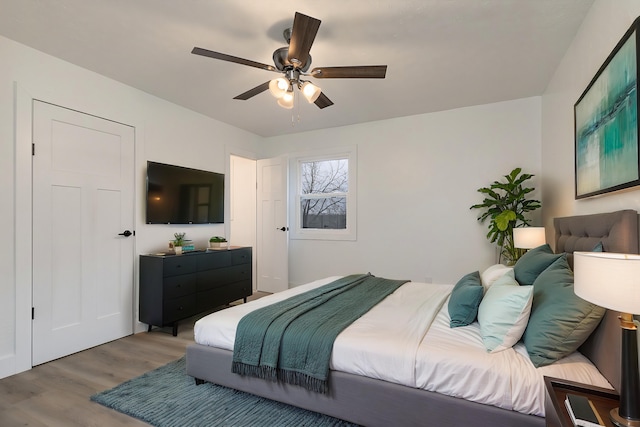 bedroom with ceiling fan and hardwood / wood-style flooring