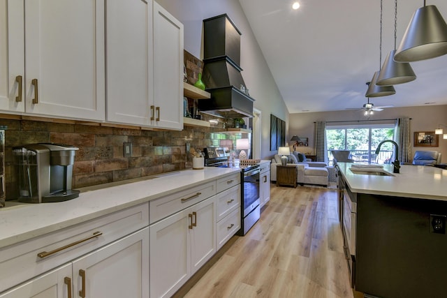 kitchen with backsplash, stainless steel electric range oven, white cabinets, and hanging light fixtures