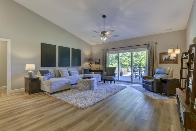 living room with vaulted ceiling, light hardwood / wood-style flooring, and ceiling fan