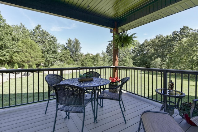 wooden terrace featuring a yard