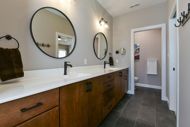 bathroom featuring tile patterned floors, vanity, and toilet