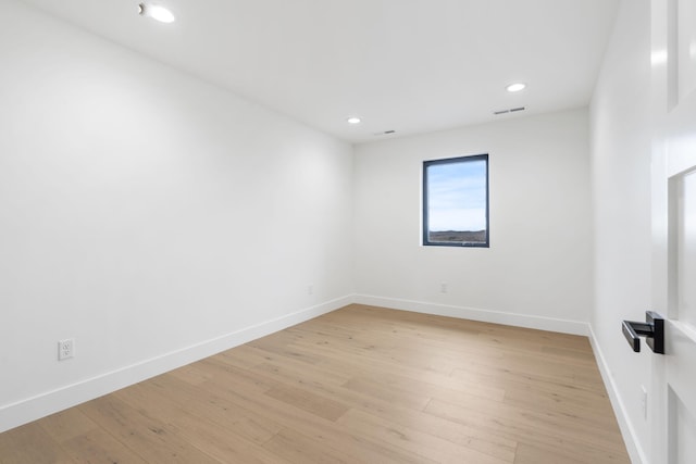 spare room with light hardwood / wood-style floors