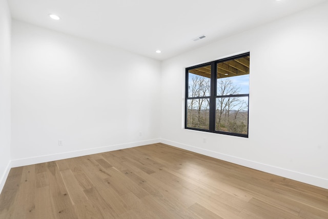 spare room featuring light hardwood / wood-style flooring