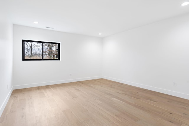 empty room with light hardwood / wood-style flooring