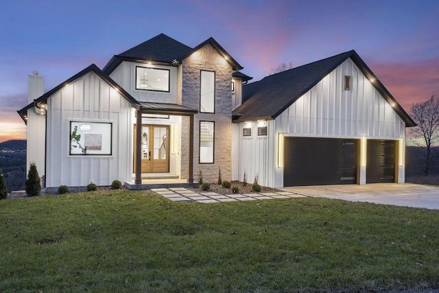 modern farmhouse with a garage and a yard