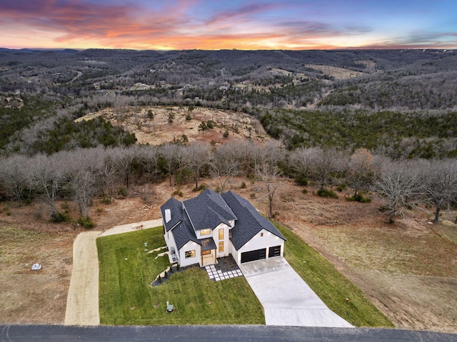 aerial view at dusk featuring a mountain view