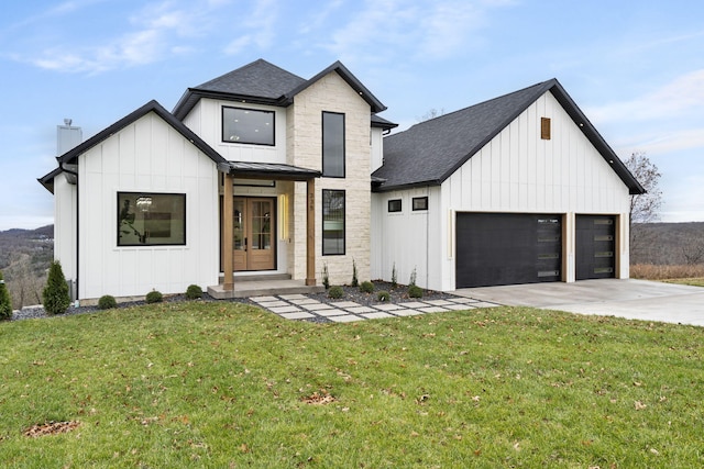 modern farmhouse style home with a garage and a front lawn