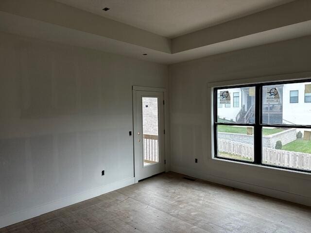 empty room featuring a tray ceiling