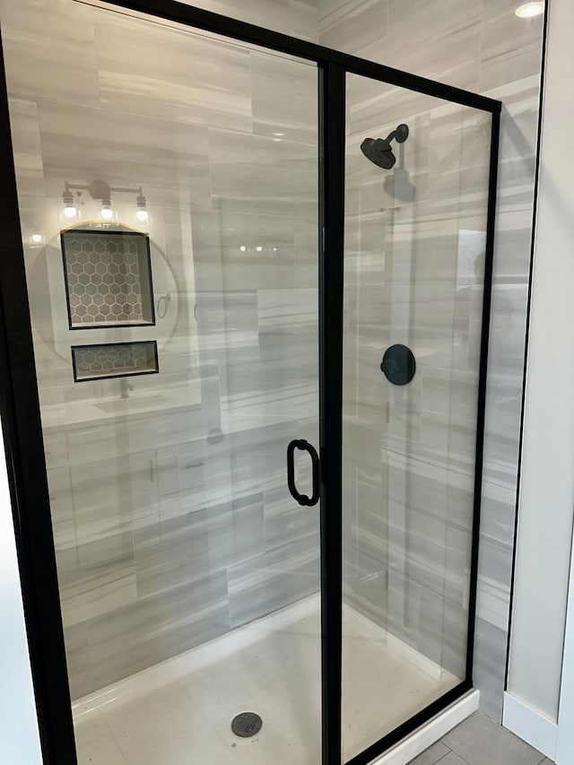 bathroom with tile patterned flooring and a stall shower