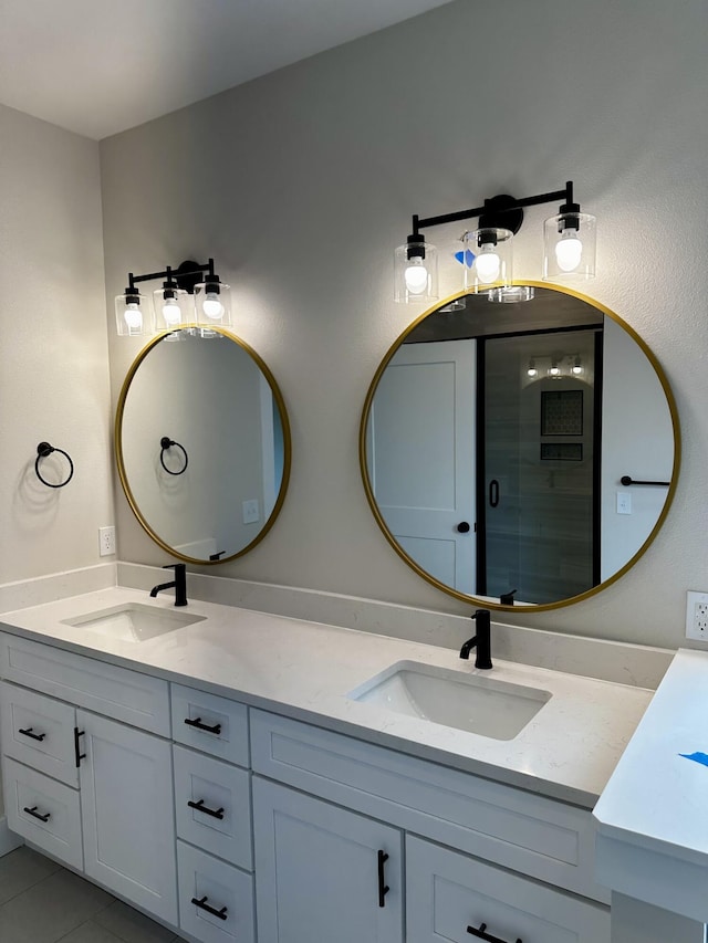 bathroom with double vanity, a sink, and tile patterned flooring