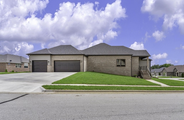 702 S Thornridge Dr, Springfield, MO 65809 - view of front facade featuring a garage, a front yard, concrete driveway, brick siding, and roof with shingles