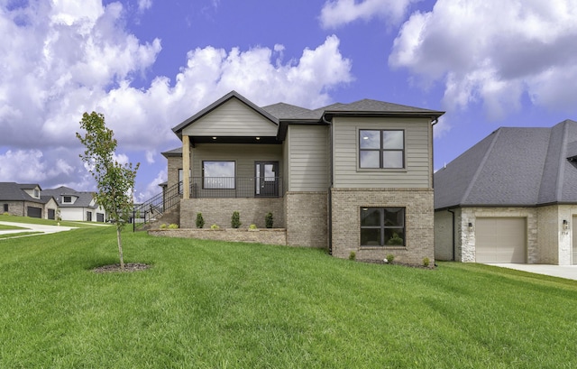 702 S Thornridge Dr, Springfield, MO 65809 - modern home with brick siding, an attached garage, a front lawn, and concrete driveway