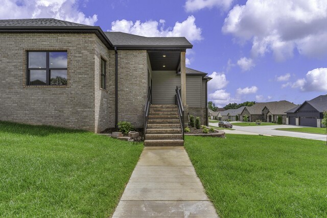 702 S Thornridge Dr, Springfield, MO 65809 - view of front of property featuring brick siding, a front yard, and a residential view