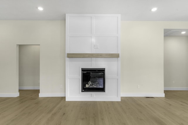 702 S Thornridge Dr, Springfield, MO 65809 - unfurnished living room with wood finished floors, baseboards, a large fireplace, and recessed lighting