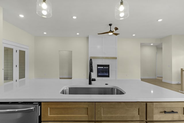 702 S Thornridge Dr, Springfield, MO 65809 - kitchen with stainless steel dishwasher, a sink, a ceiling fan, recessed lighting, and a large fireplace