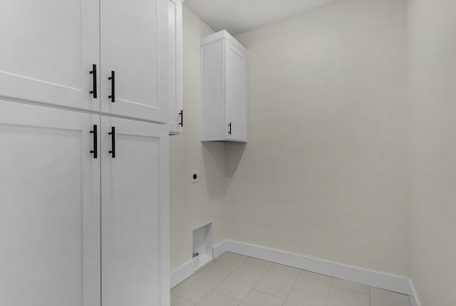 702 S Thornridge Dr, Springfield, MO 65809 - washroom with hookup for an electric dryer, cabinet space, baseboards, and light tile patterned floors