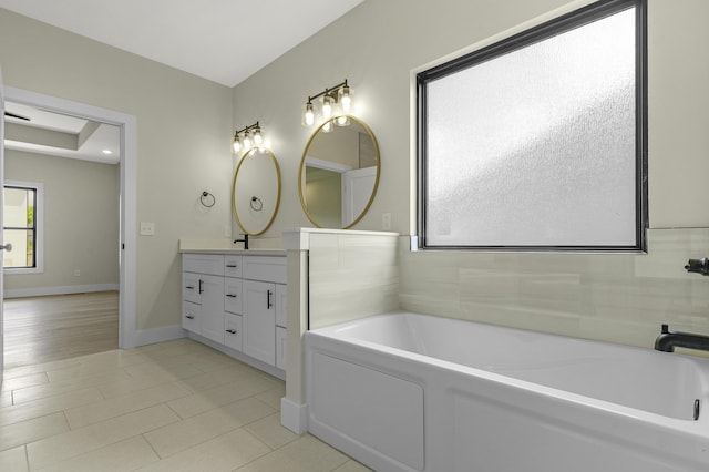 702 S Thornridge Dr, Springfield, MO 65809 - full bathroom featuring double vanity, a garden tub, baseboards, and tile patterned flooring
