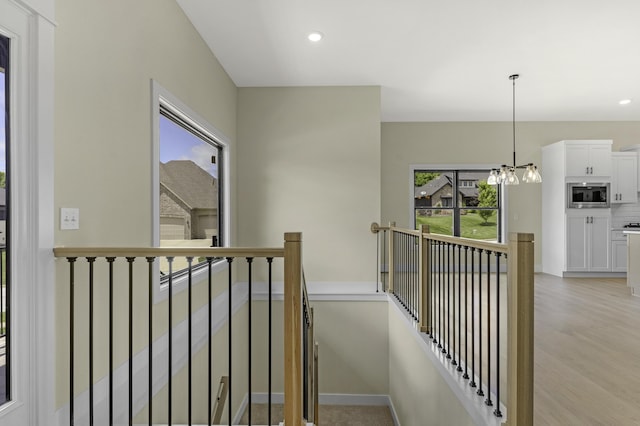 702 S Thornridge Dr, Springfield, MO 65809 - hallway featuring an upstairs landing, light wood-type flooring, recessed lighting, a chandelier, and baseboards