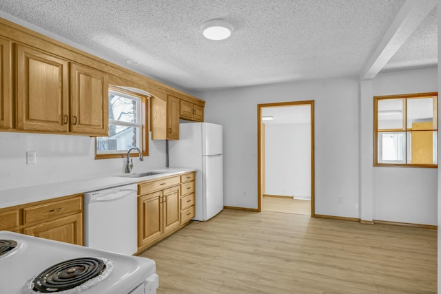 kitchen featuring beam ceiling, white appliances, light hardwood / wood-style floors, and sink