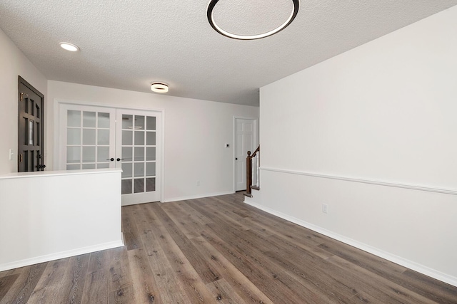 interior space featuring wood-type flooring and a textured ceiling