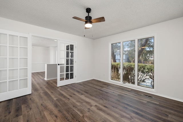 unfurnished room with french doors, a textured ceiling, dark hardwood / wood-style floors, and ceiling fan