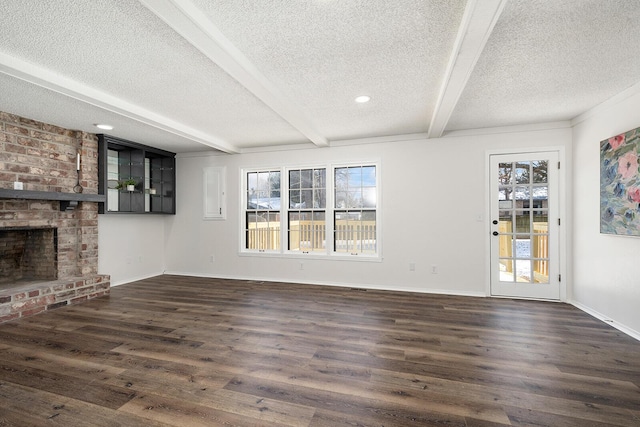 unfurnished living room with beamed ceiling, dark hardwood / wood-style flooring, a textured ceiling, and a fireplace