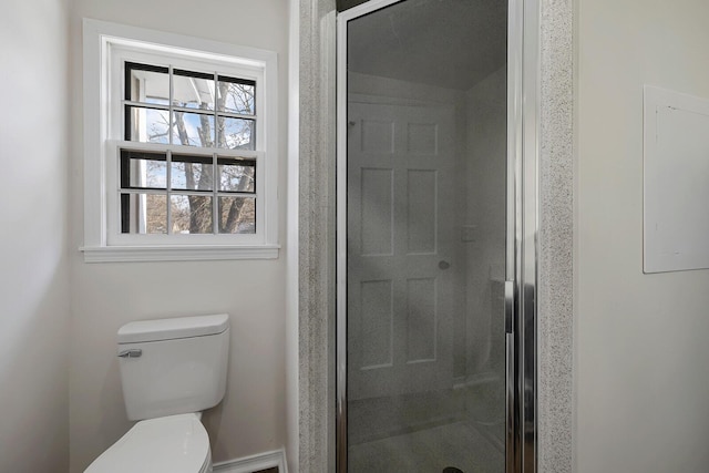 bathroom featuring toilet and an enclosed shower