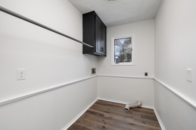 laundry area featuring cabinets, washer hookup, hookup for an electric dryer, a textured ceiling, and dark wood-type flooring