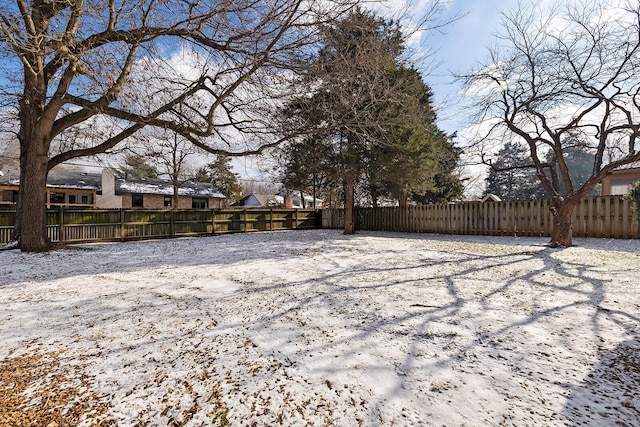 view of yard layered in snow