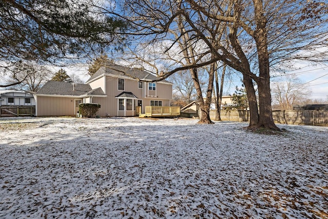 yard layered in snow with a deck