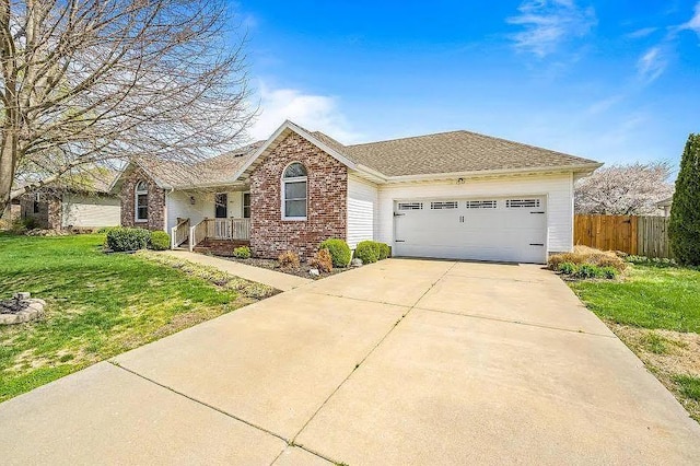 ranch-style house featuring a garage and a front yard