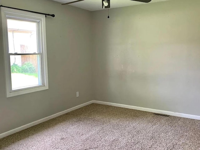 carpeted spare room with ceiling fan and a healthy amount of sunlight