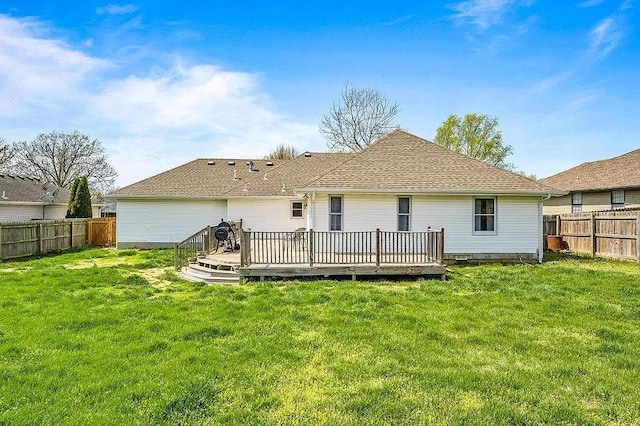 rear view of house with a yard and a wooden deck