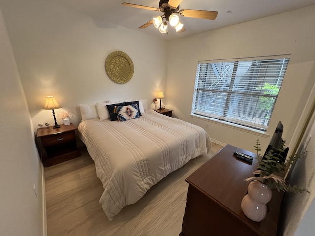 bedroom with ceiling fan and light wood-type flooring